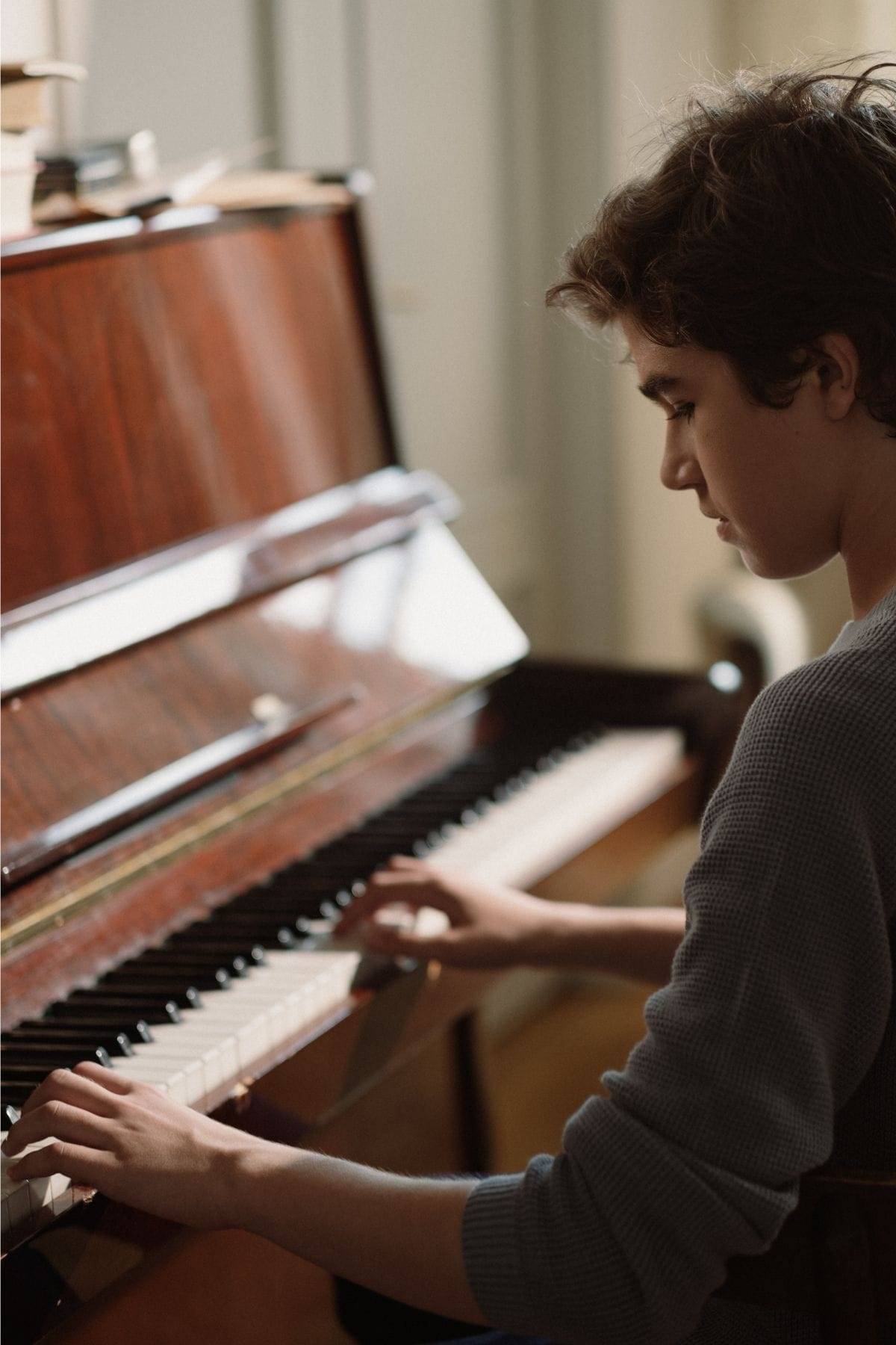 Boy learning to play piano